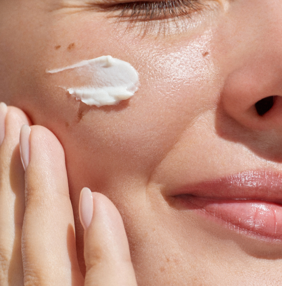 Close-up of AHA exfoliating scrub being gently applied to clean skin