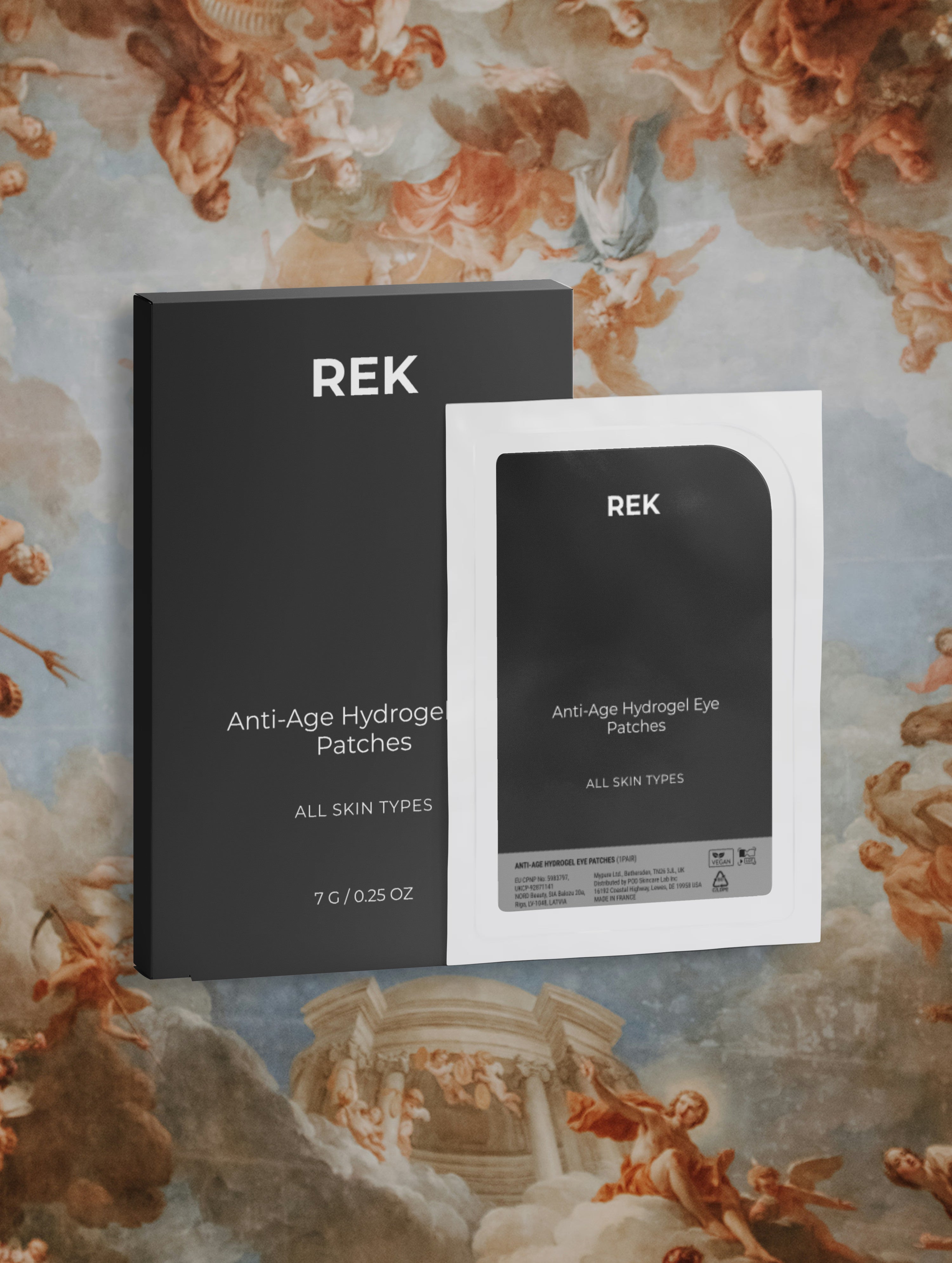 REK Anti-Age Hydrogel Eye Patches packaging, featuring a black outer box and an individual white packet with a black patch insert, set against a classical fresco background.