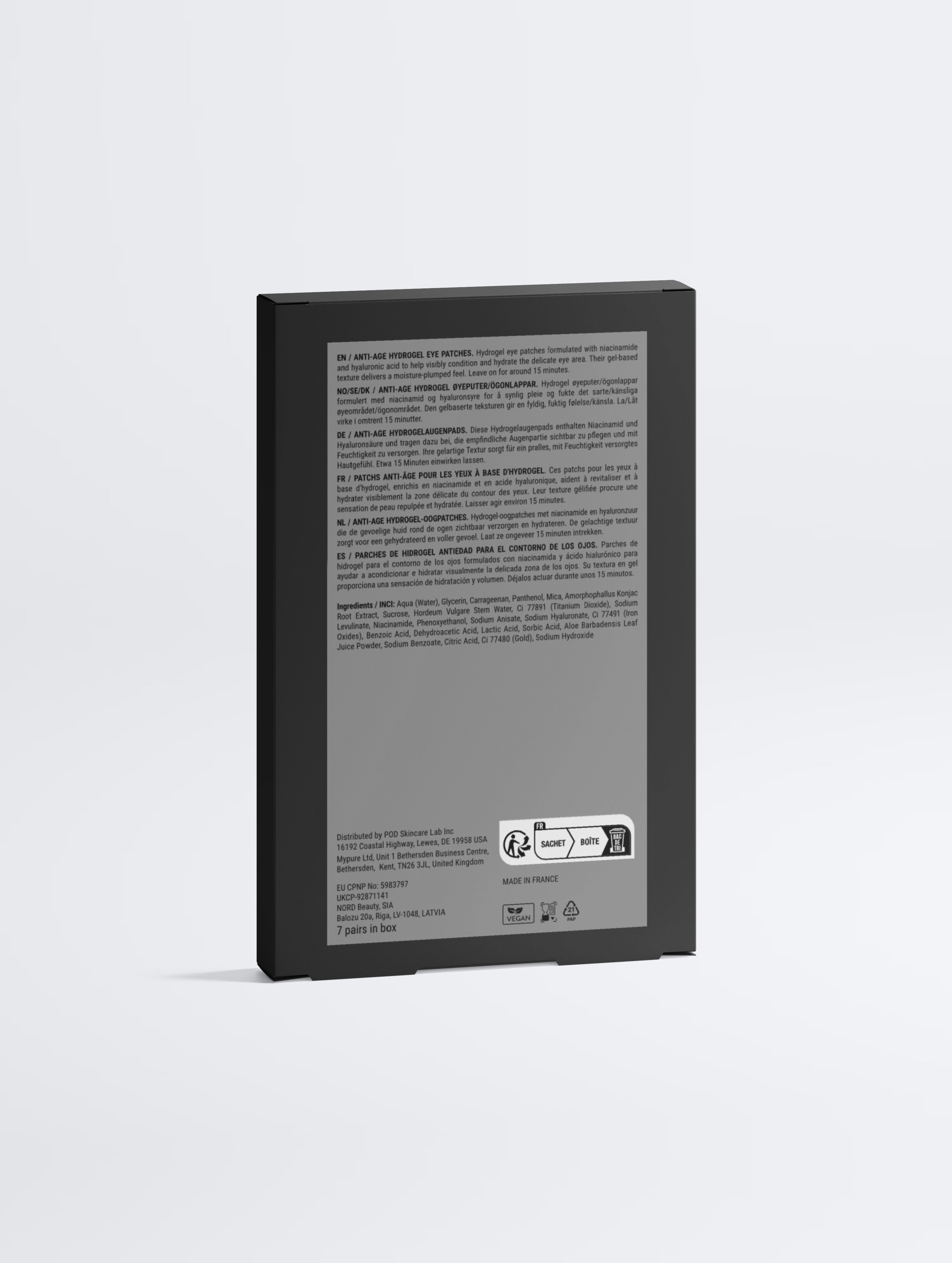The back of a black rectangular electronic device, showing printed specifications, regulatory text, and a power adapter plug, on a light gray background.